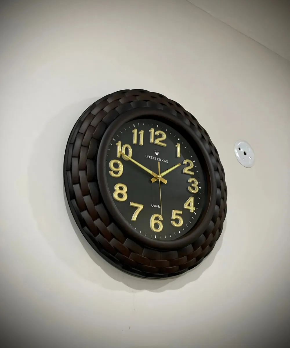 Side angle view of black antique wall clock with textured frame