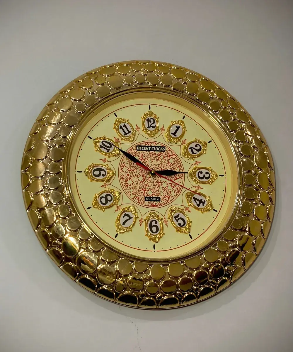 Close-up of golden fancy wall clock frame and decorative number layout