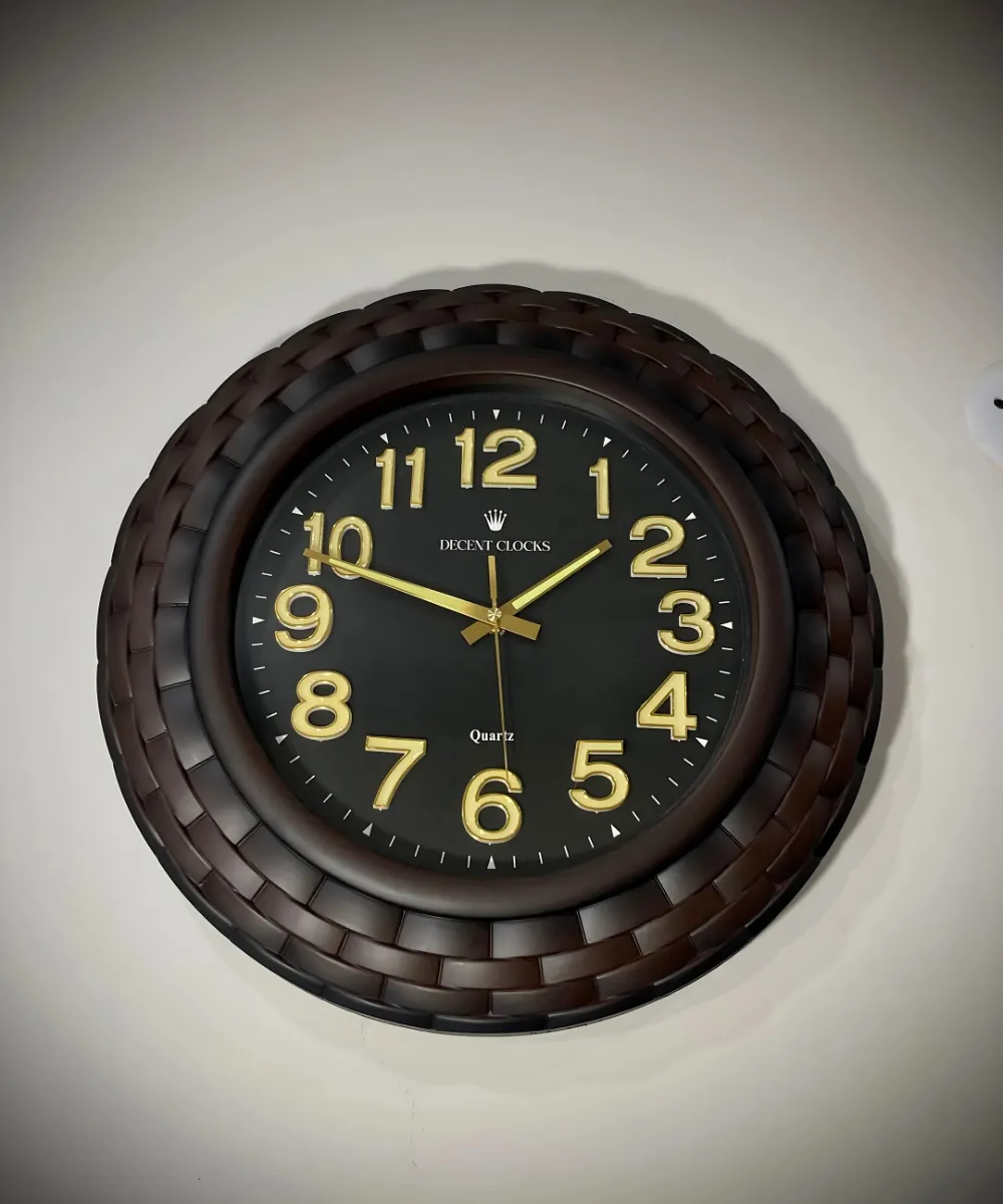 oversized black wall clock with golden numbers